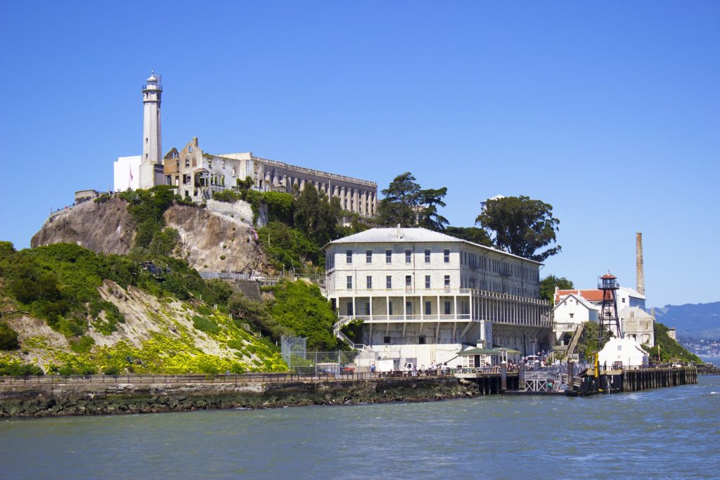 a building on a hill by water