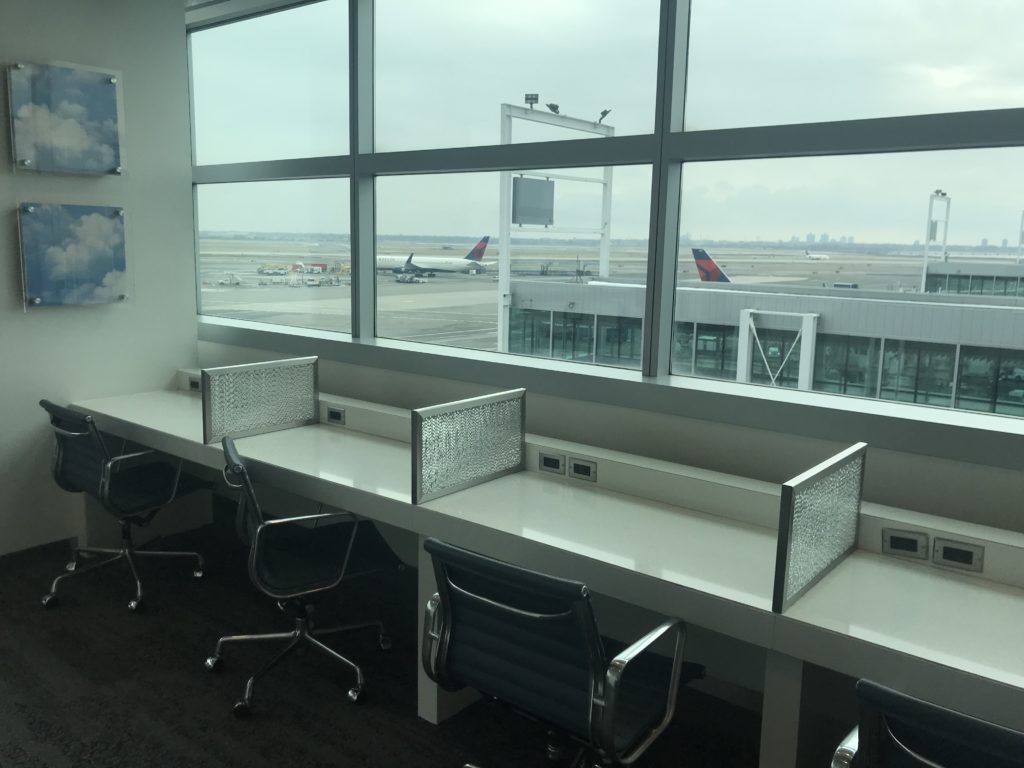 a room with a window and a row of desks