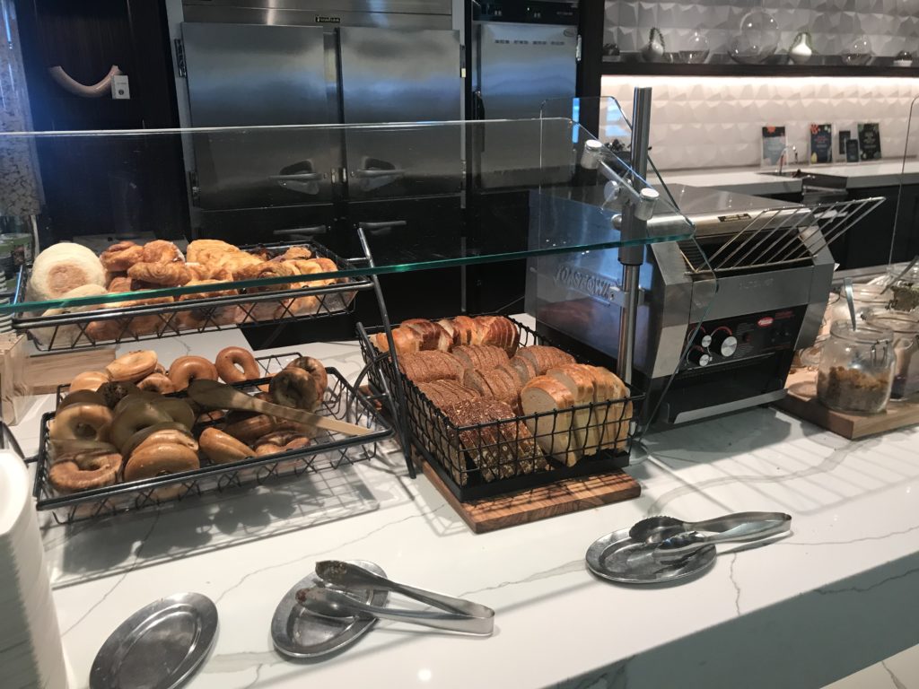 a counter with different types of bread and pastries