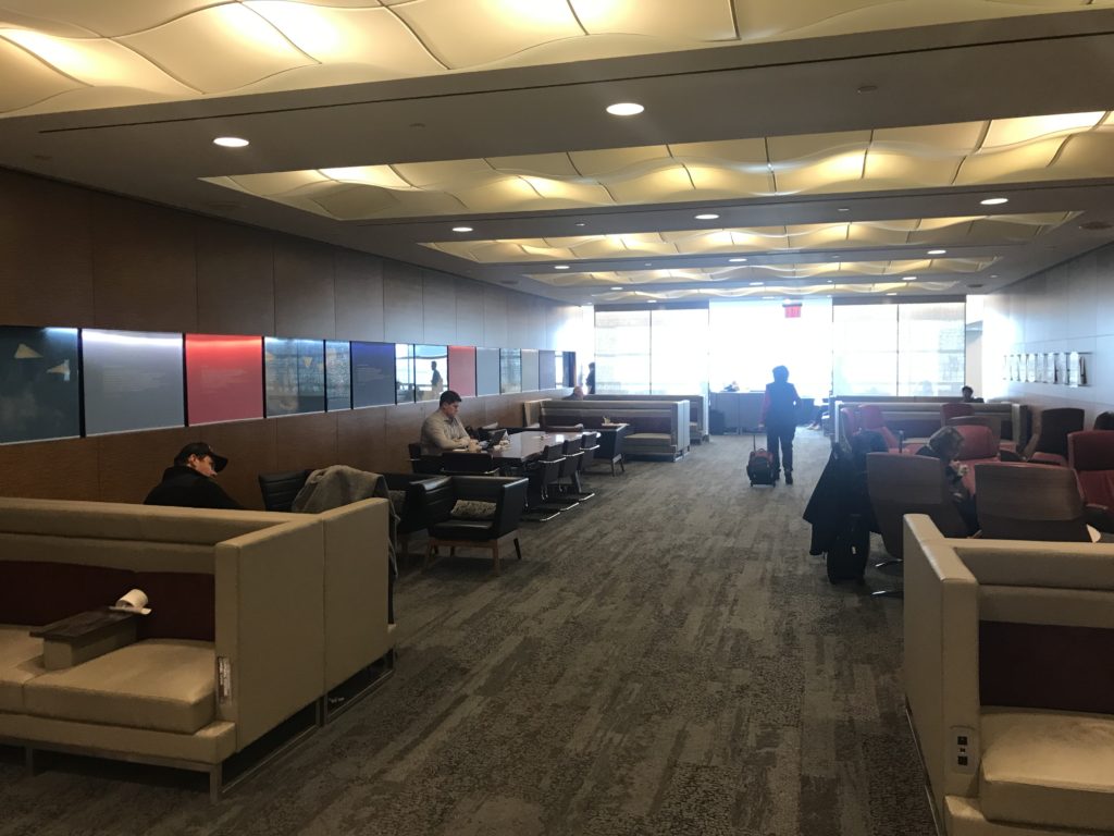 a group of people sitting in a room with chairs and tables