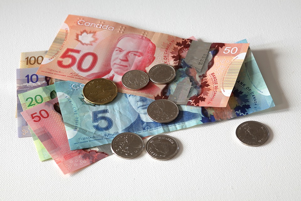 a group of canadian currency bills and coins