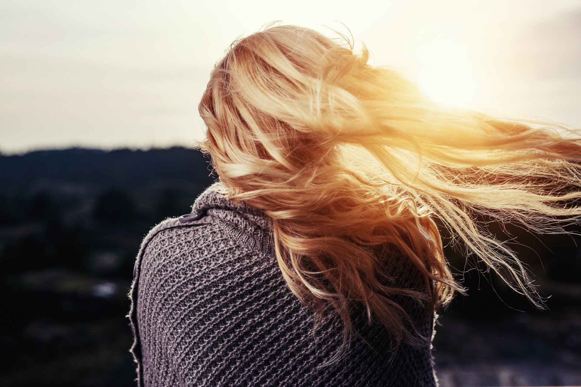 a woman with her hair blowing in the wind