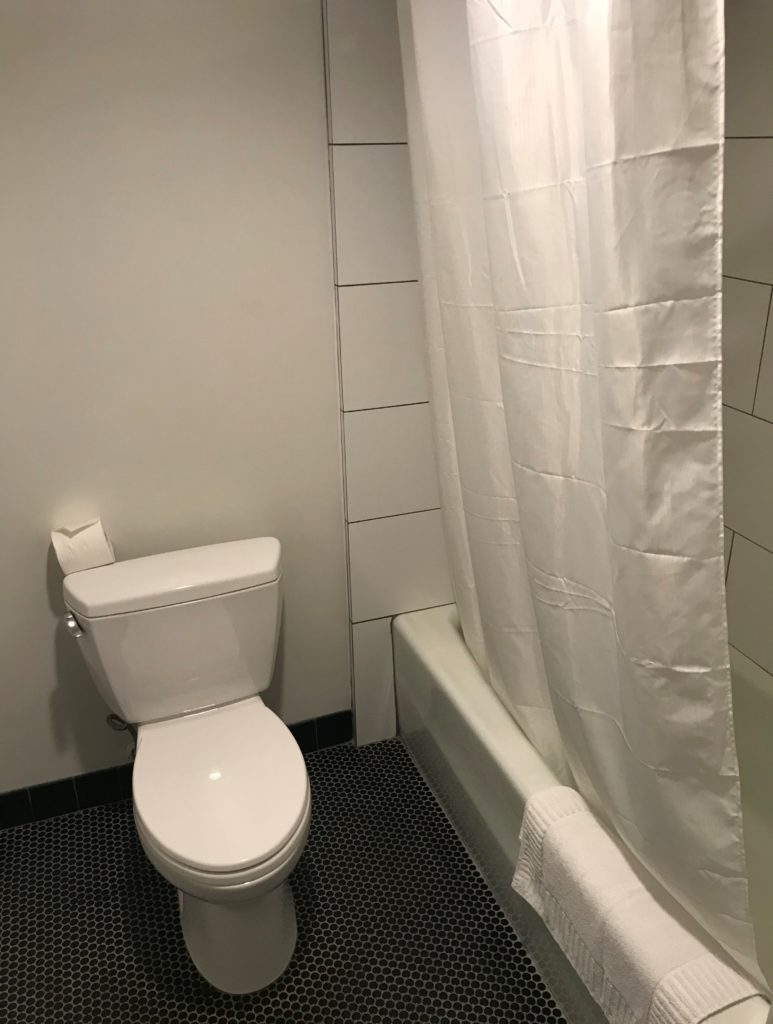 a white shower curtain in a bathroom