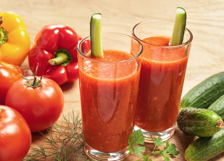 two glasses of tomato juice with cucumber and pepper