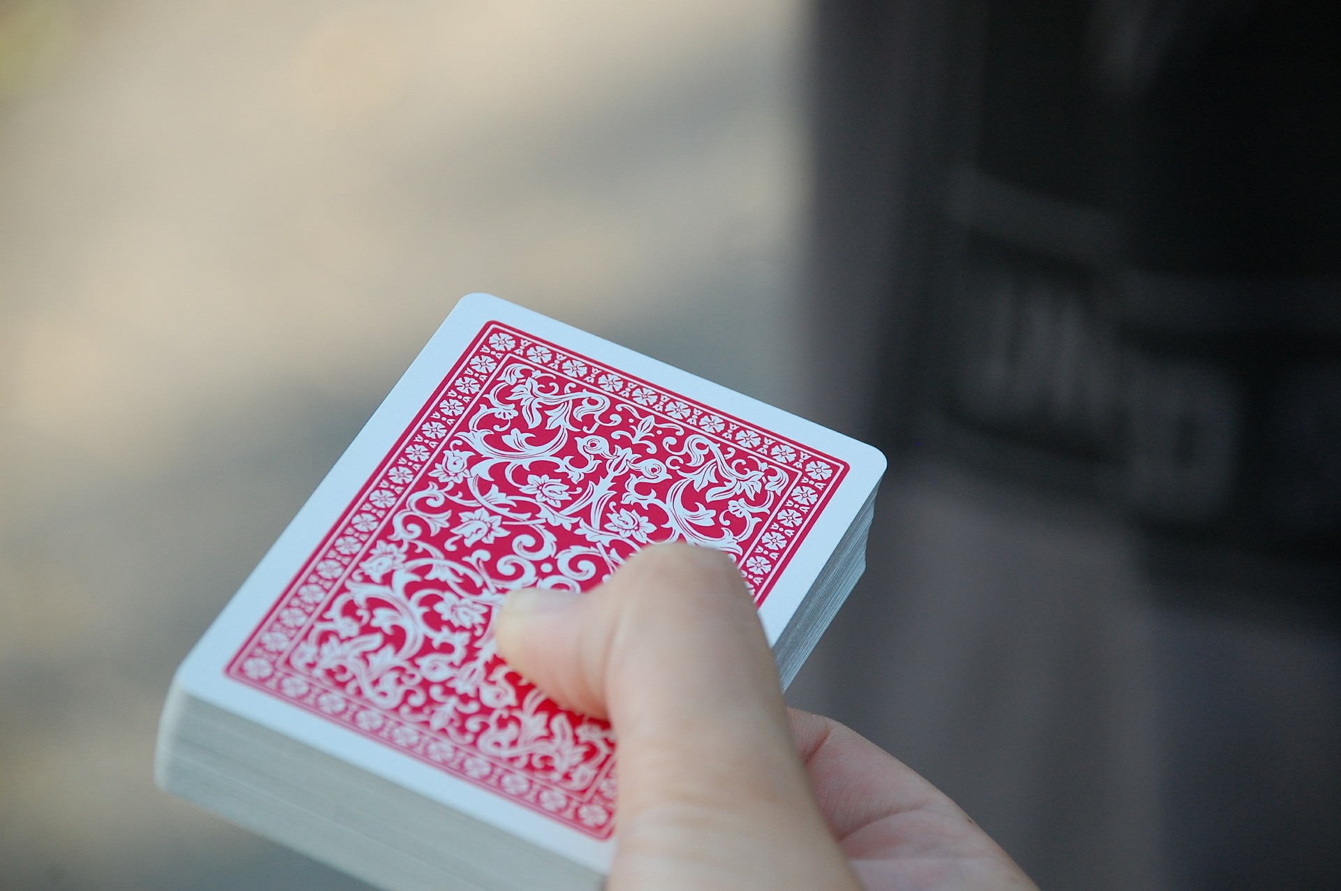 a hand holding a deck of cards