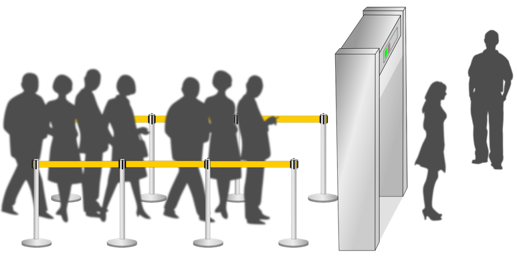 a group of people standing in front of a barrier