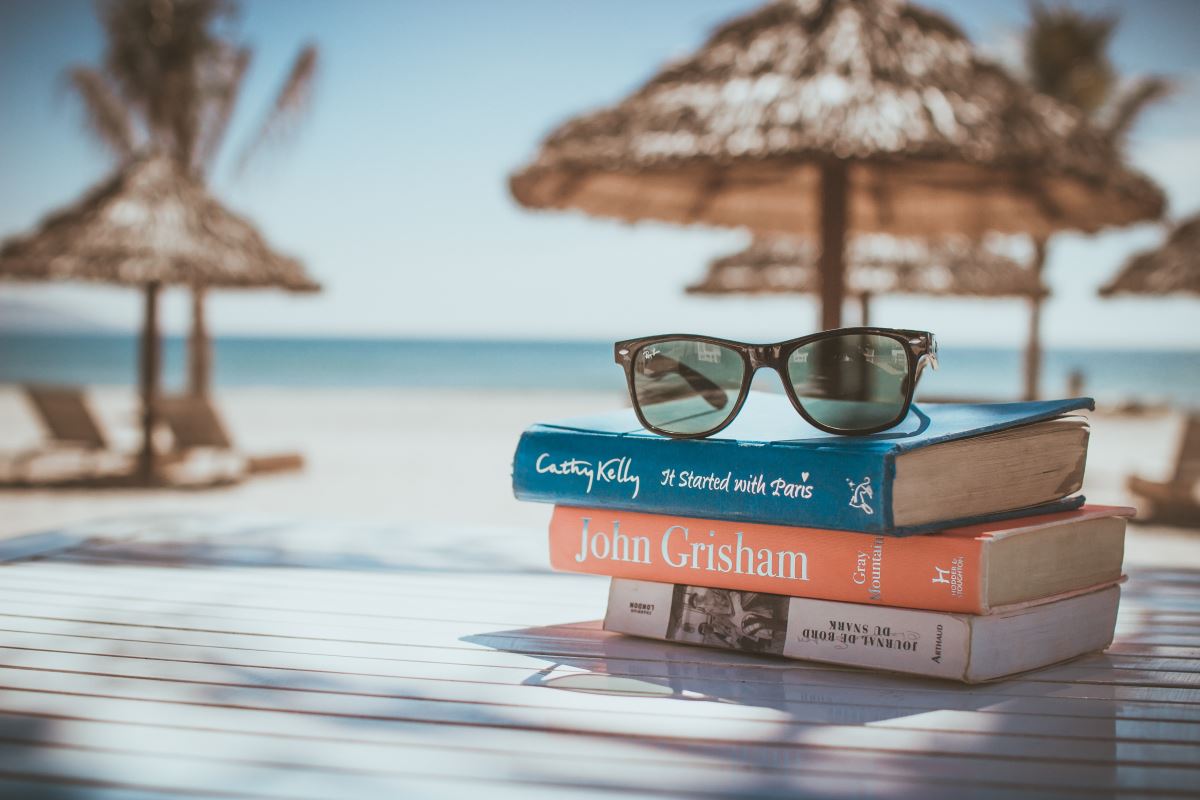 a stack of books with sunglasses on top of each other