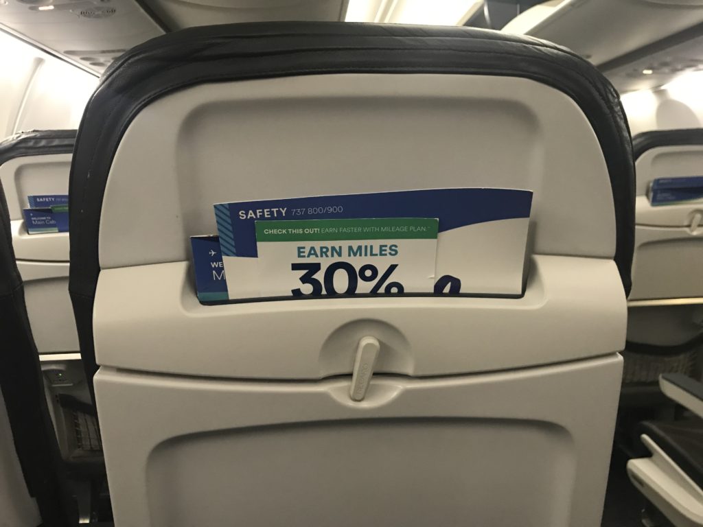a sign on the arm rest of an airplane