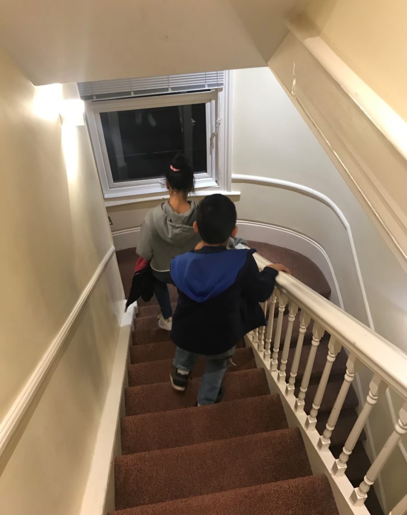 a boy and girl climbing up stairs