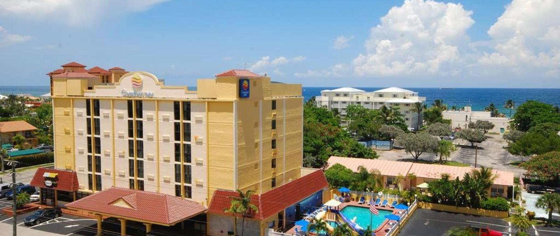 a building with a pool and trees