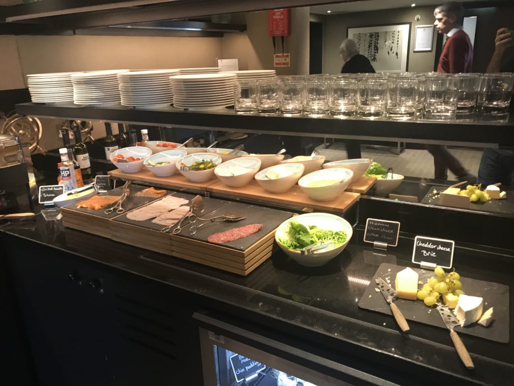 a buffet with plates and food on shelves