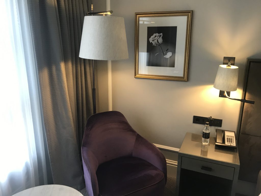 a purple chair next to a lamp