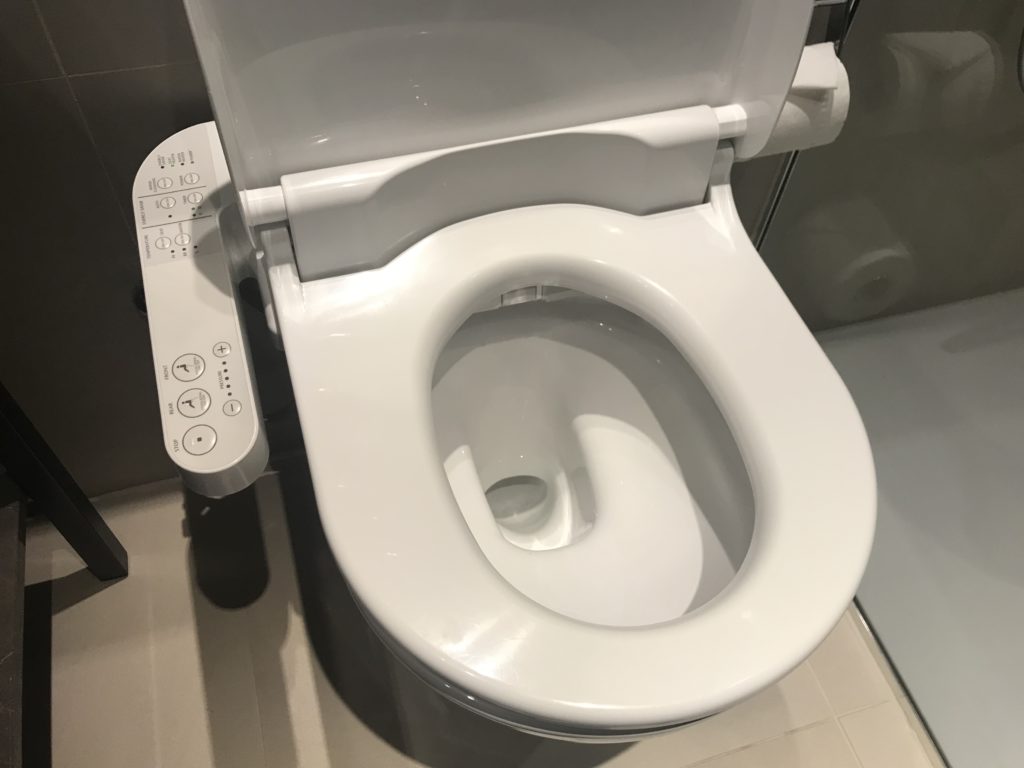 a white toilet with the seat up
