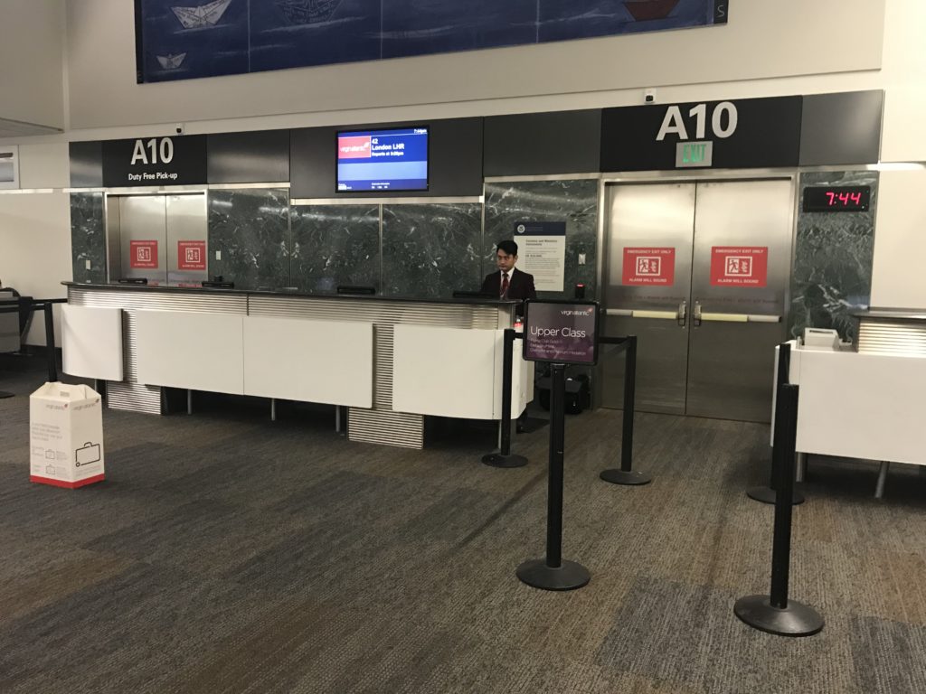 a man standing at a counter in an airport