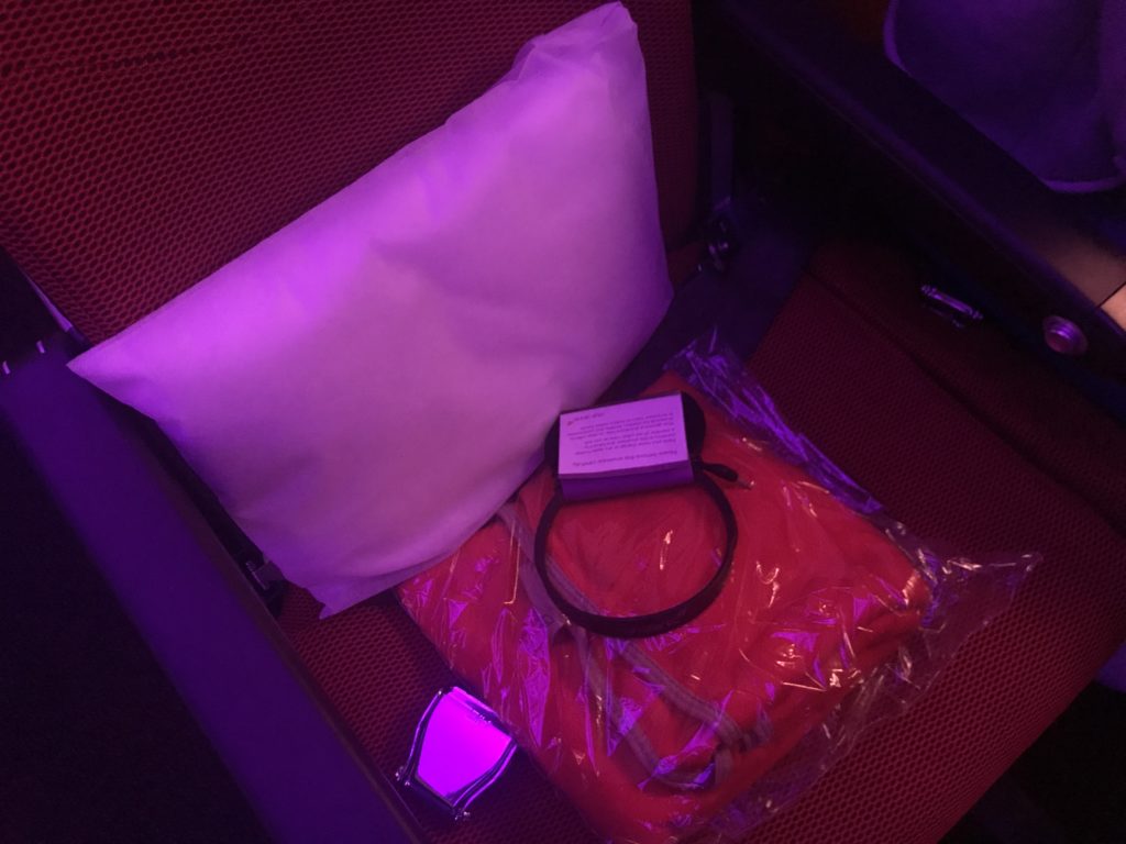 a pillow and a headband on a red seat