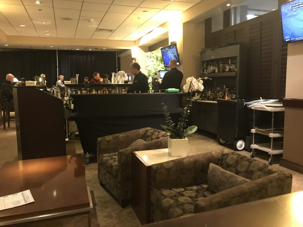 a room with a bar and people in the background