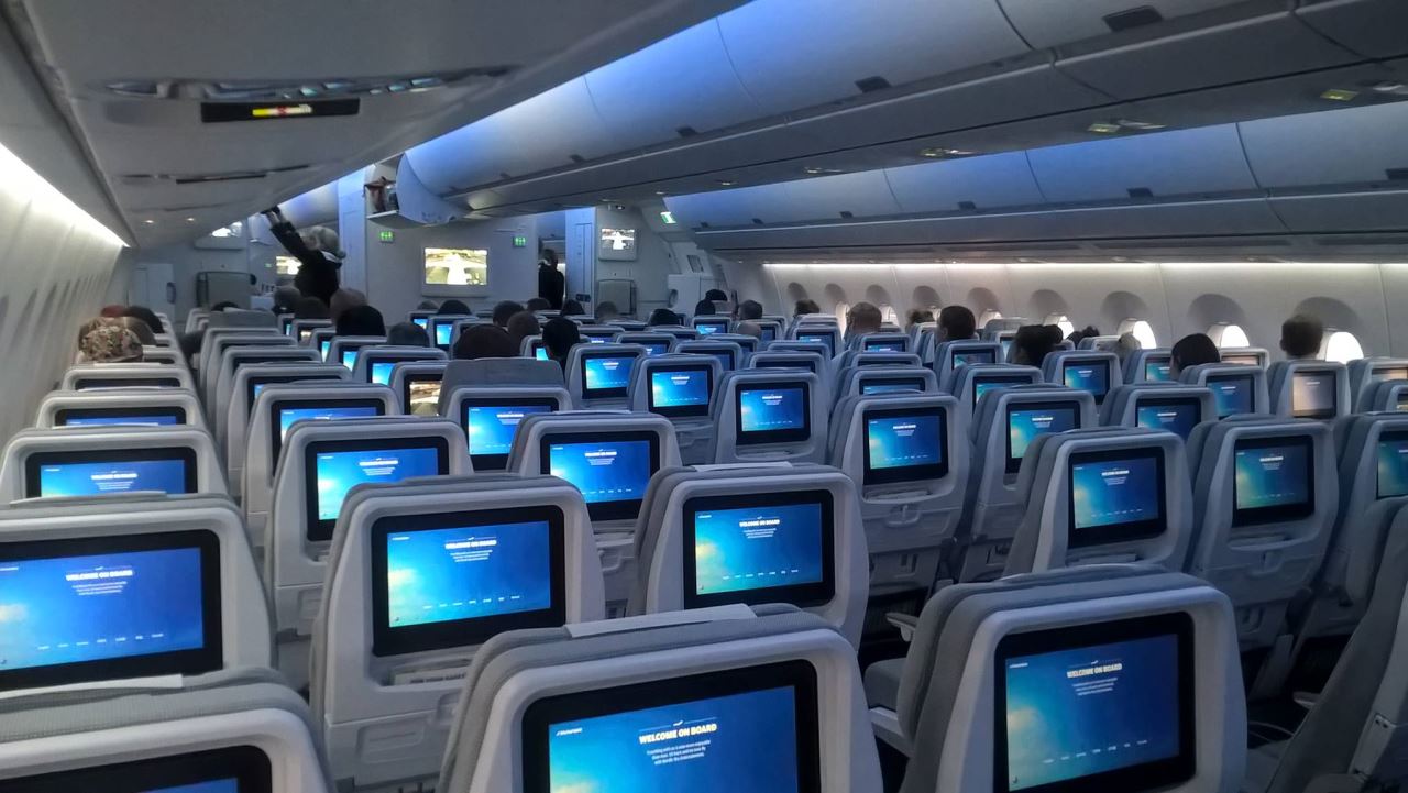 an airplane with rows of seats and monitors