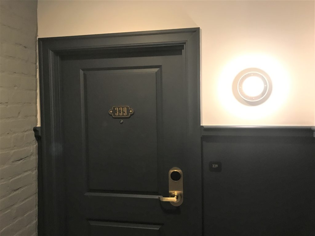 a door with a light on the wall