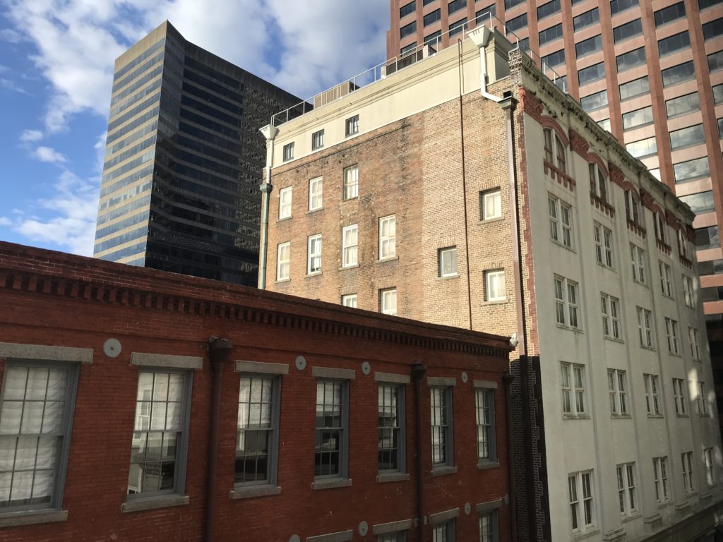 a group of buildings with tall buildings in the background