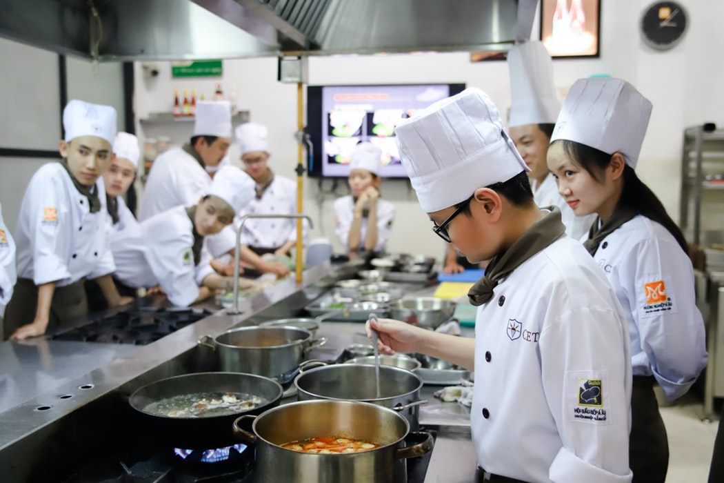 a group of people in a kitchen