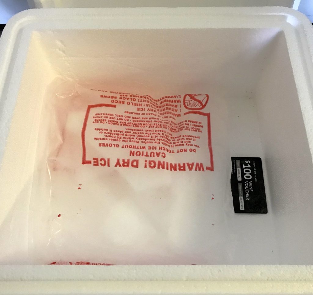 a white styrofoam container with red text inside