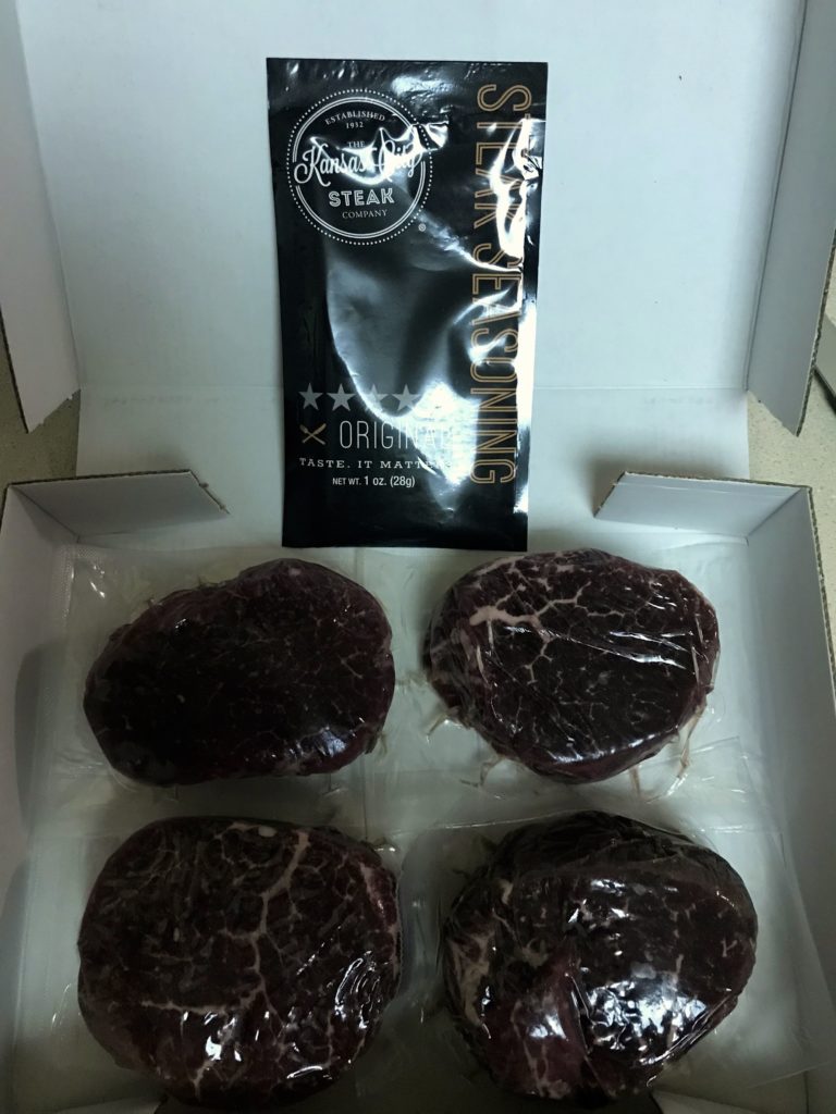 a box of steaks in plastic wrap