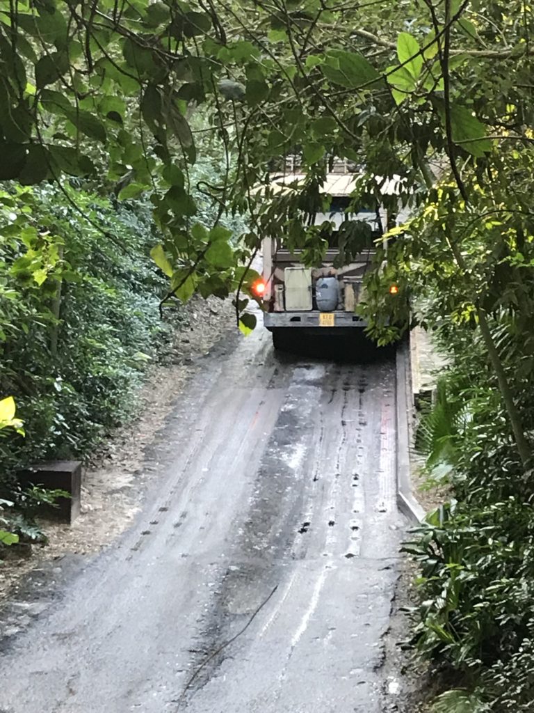 a truck driving down a dirt road