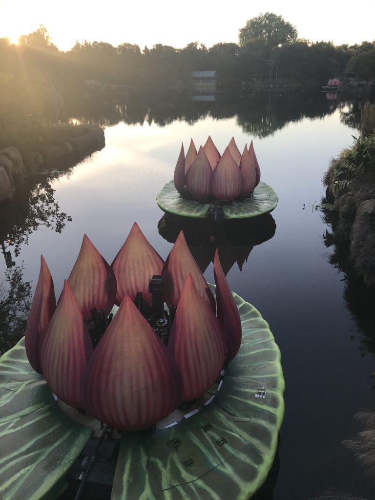 a group of fake flowers on a pond