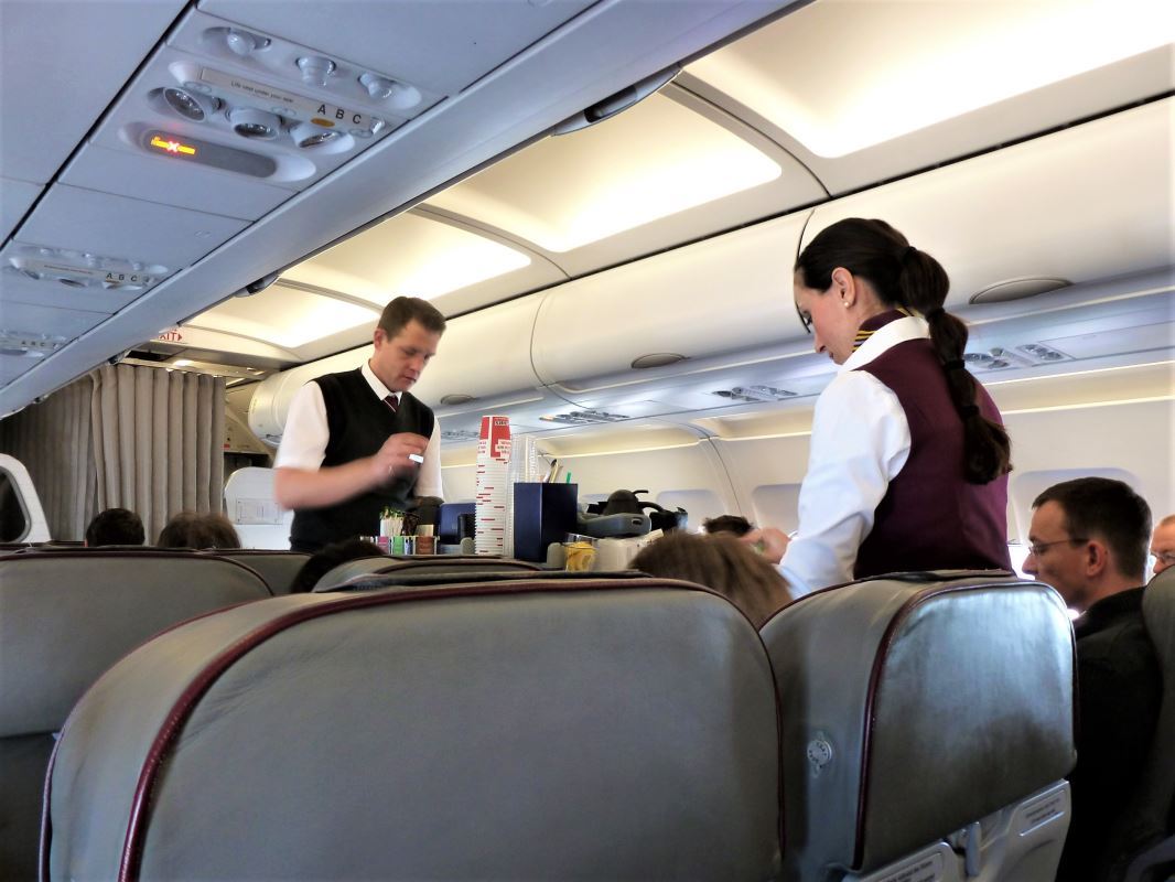 a man and woman in uniform on an airplane