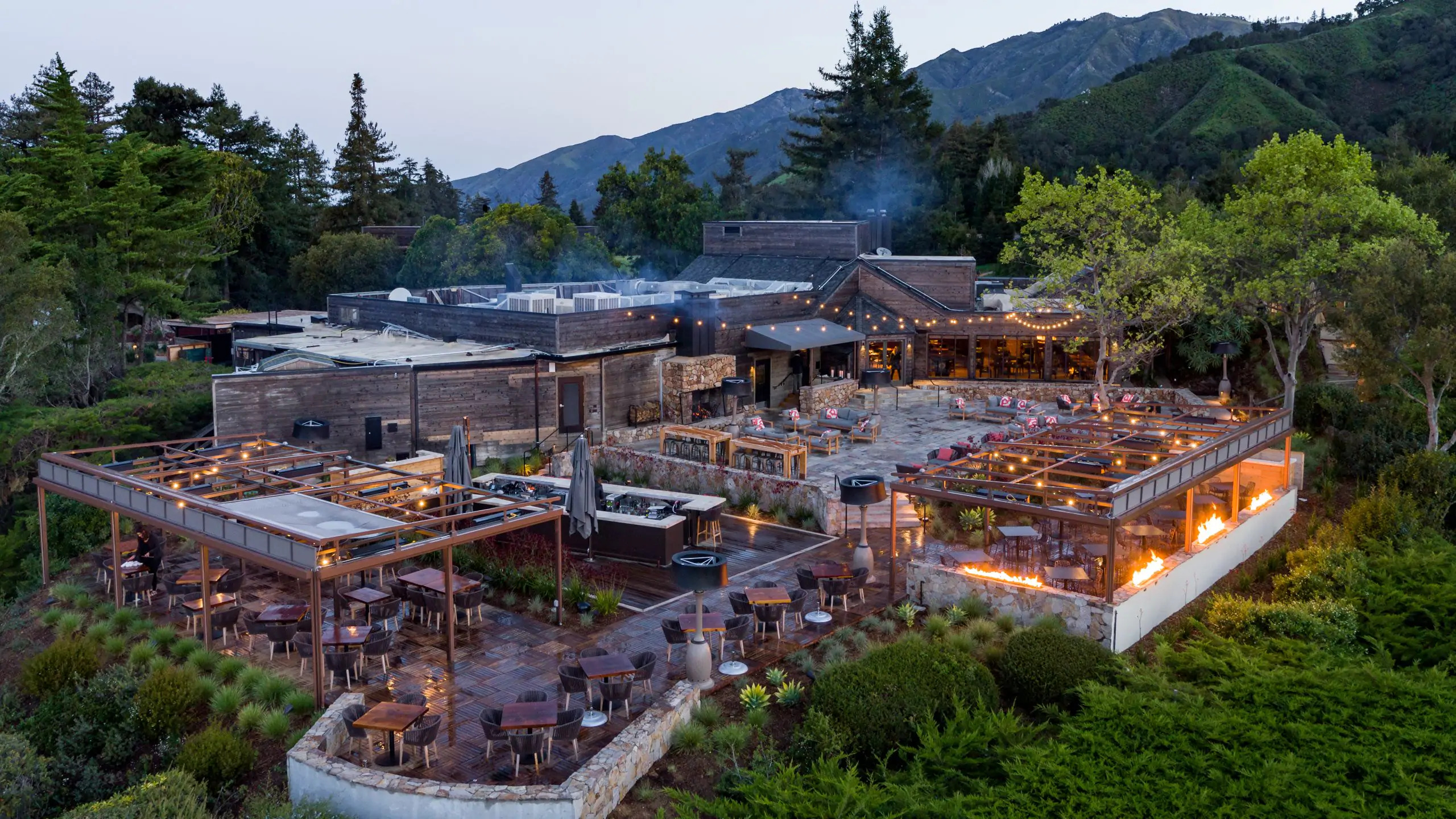 a building with tables and chairs and trees