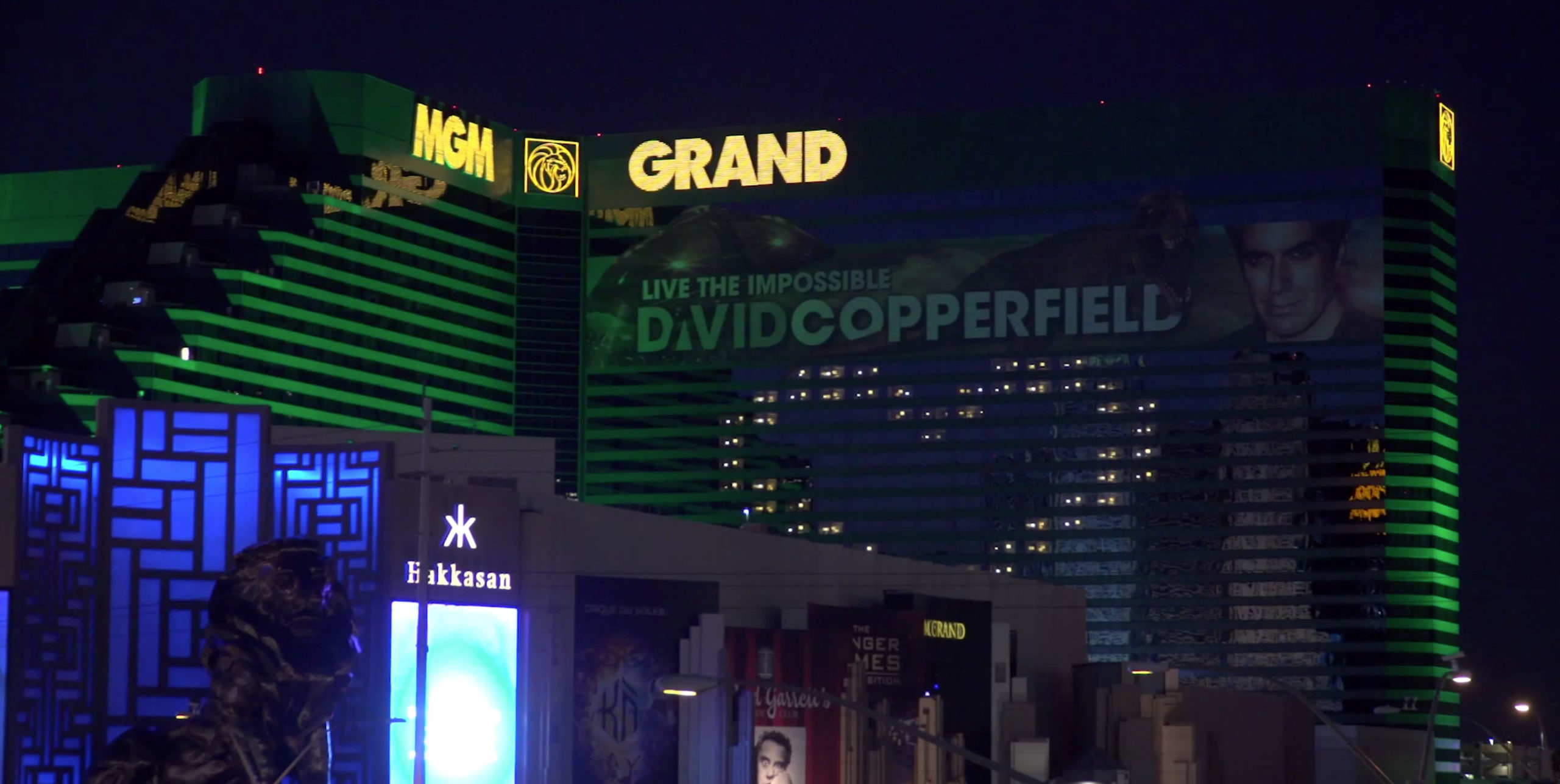 a large building with green lights