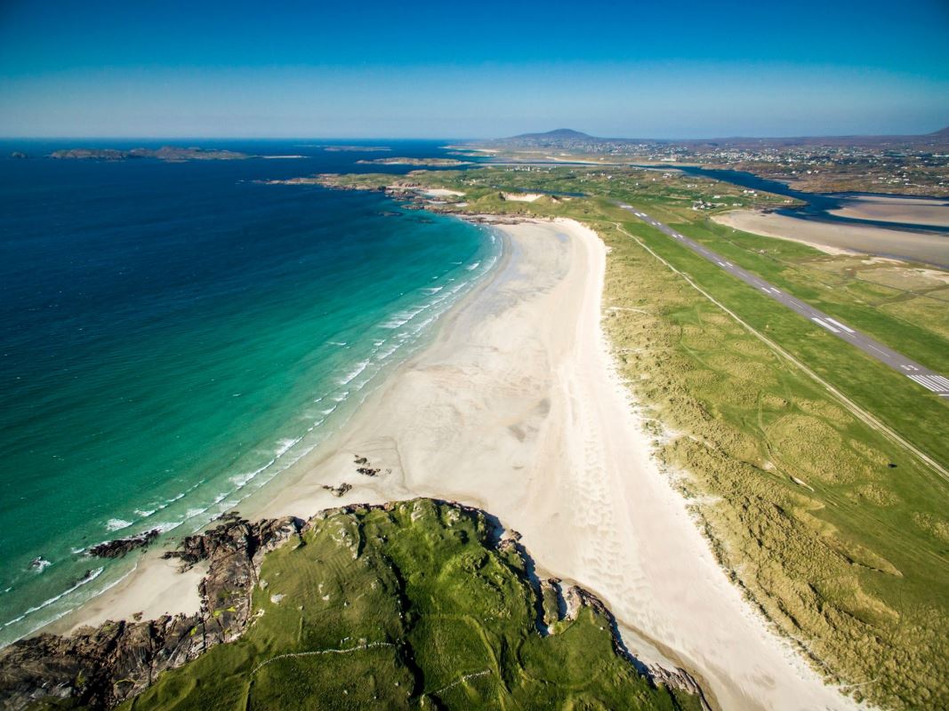 a beach with land and water