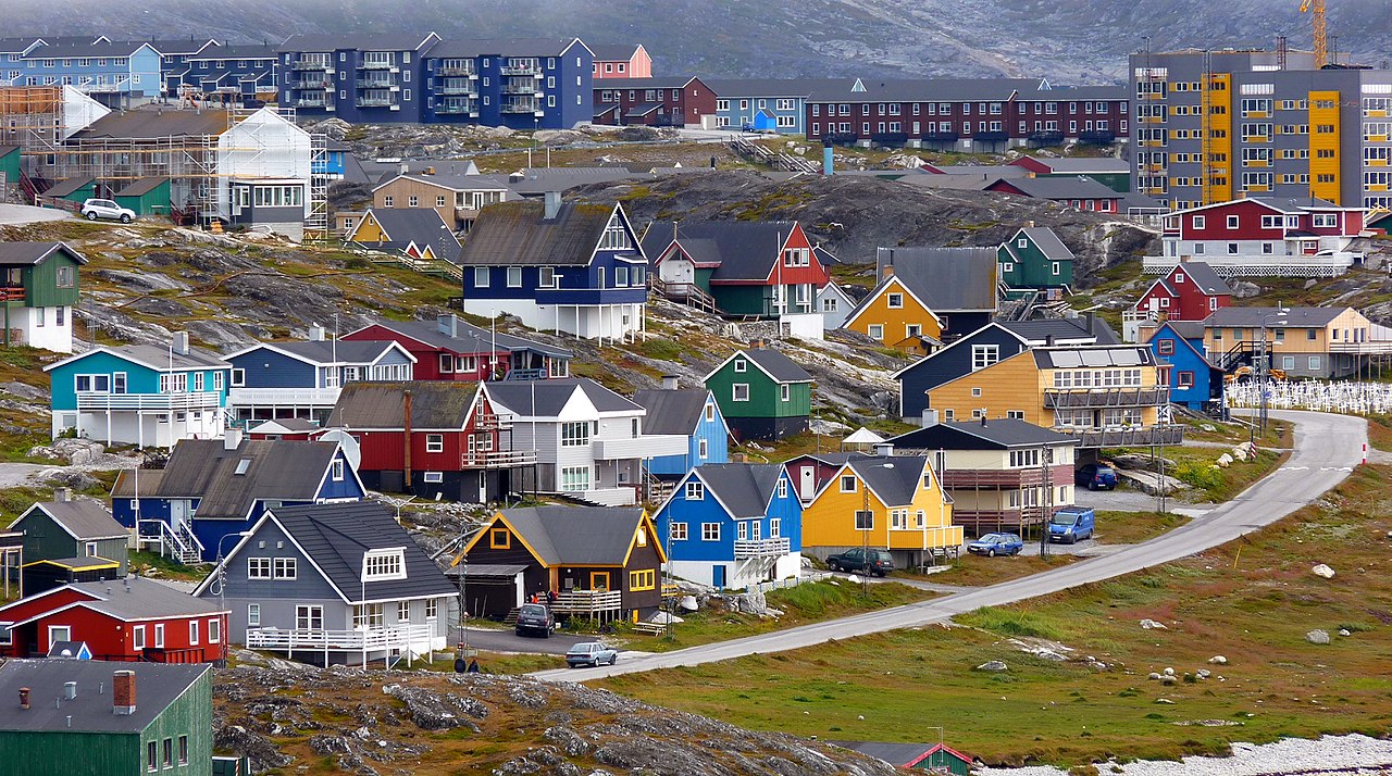 a group of colorful houses on a hill