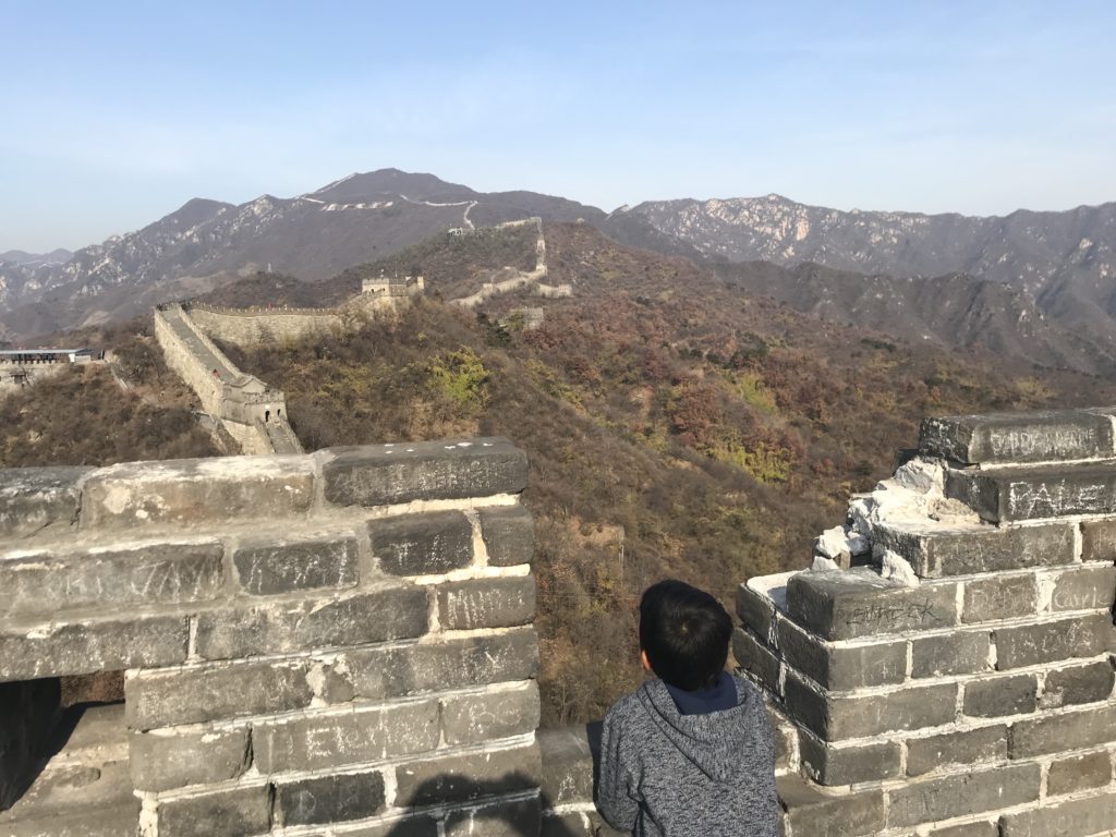 a boy looking at a wall