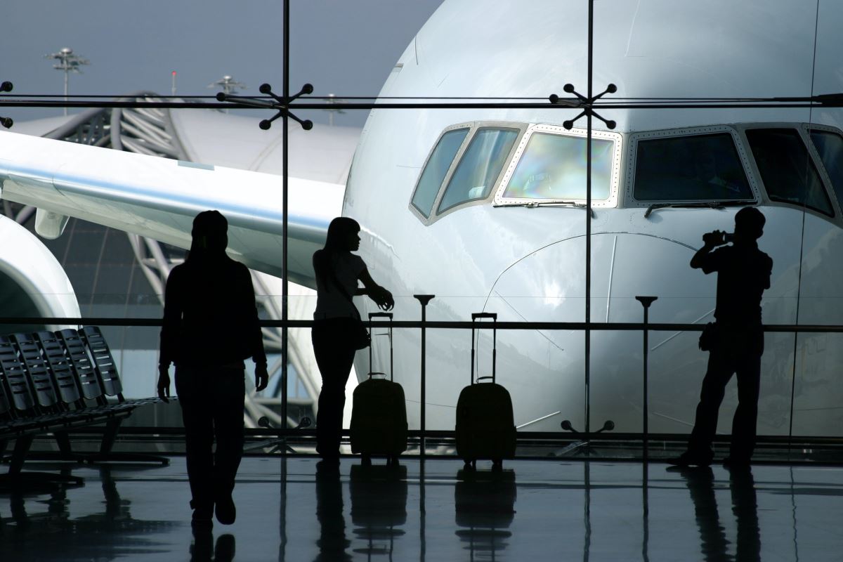 people standing in front of a plane