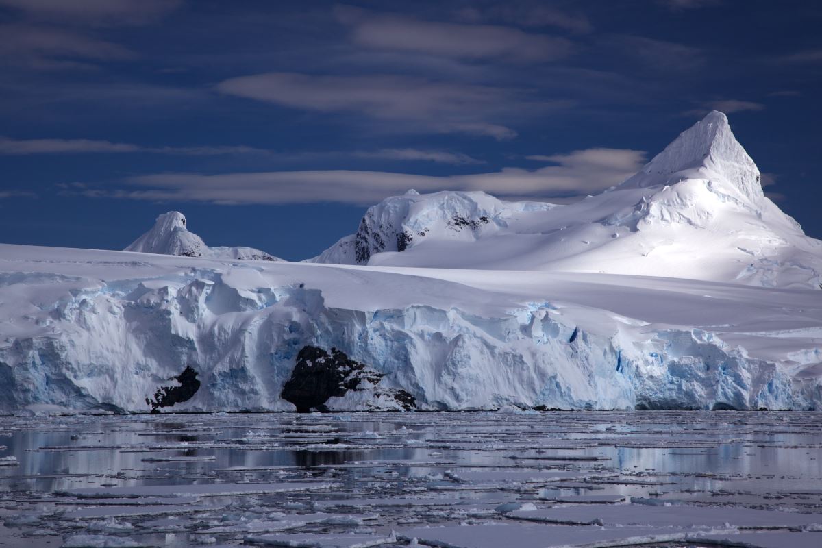 a snowy mountain with ice and water