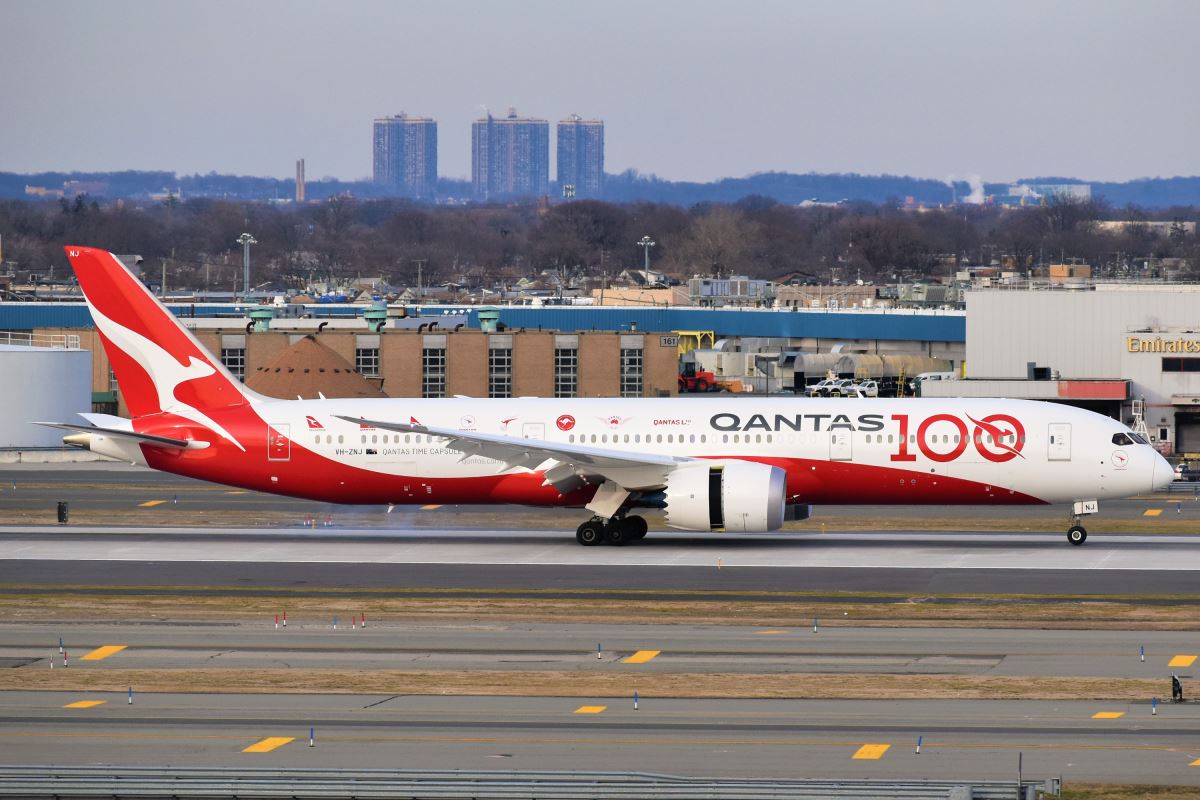 a red and white airplane on a runway