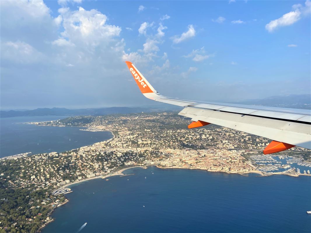 an airplane wing over a city