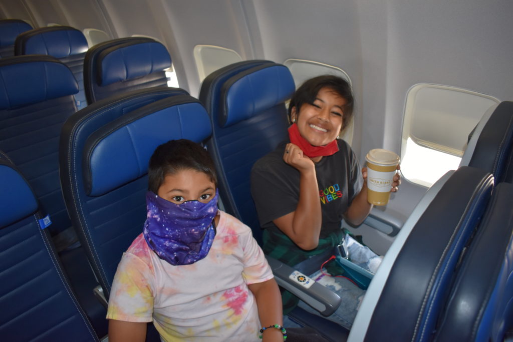 two people sitting in a plane