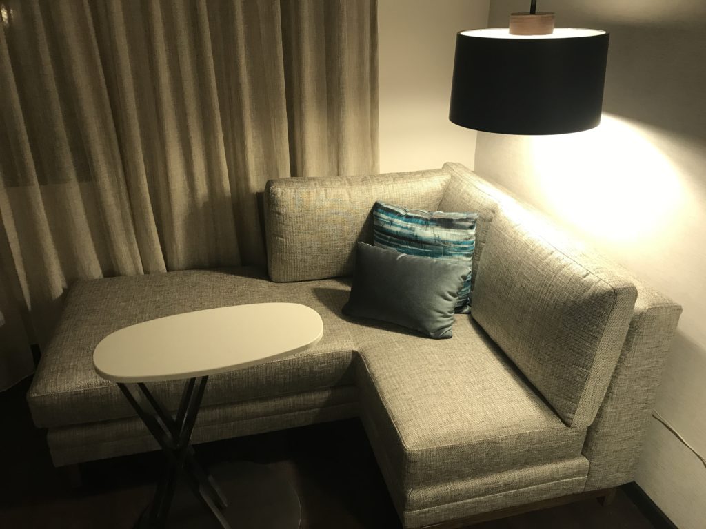 a couch with a lamp and a table