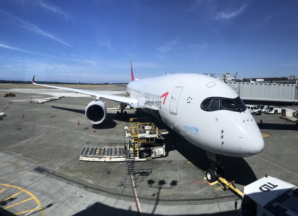a white airplane parked at an airport