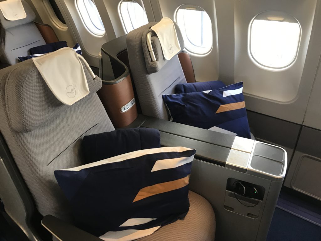 a seat with pillows on the back of the seat