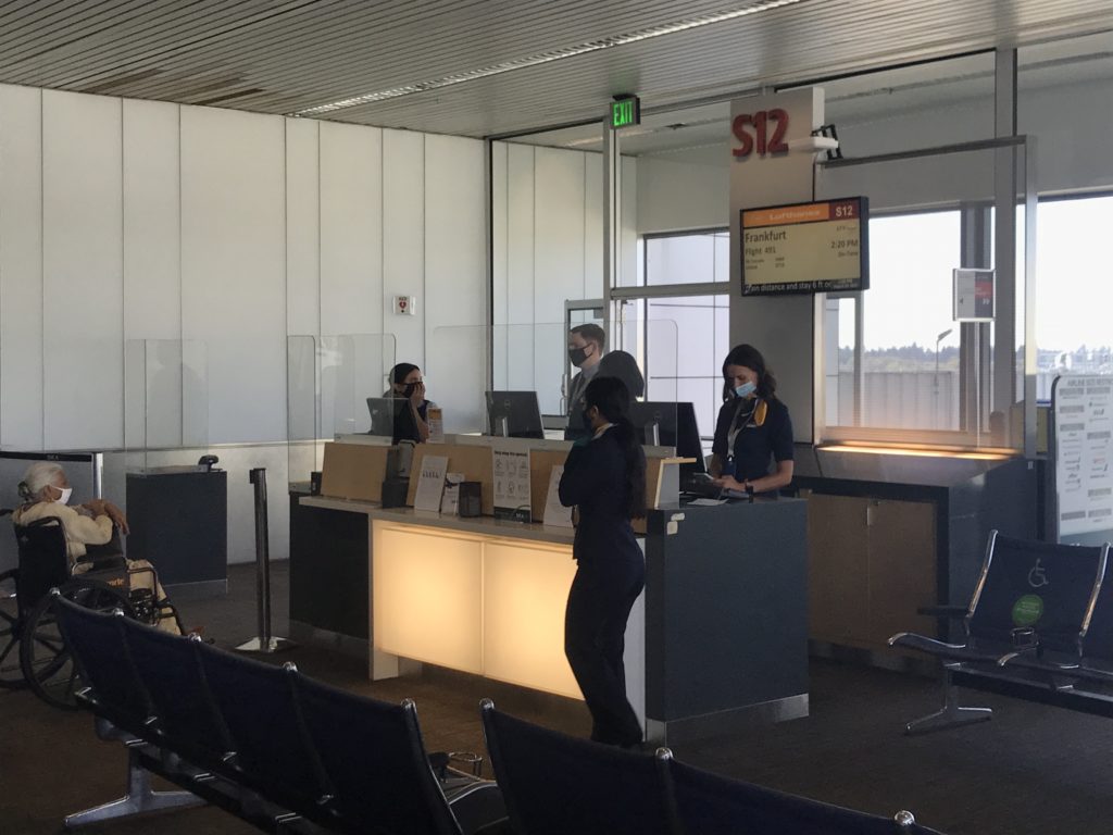 people standing at a desk in a building