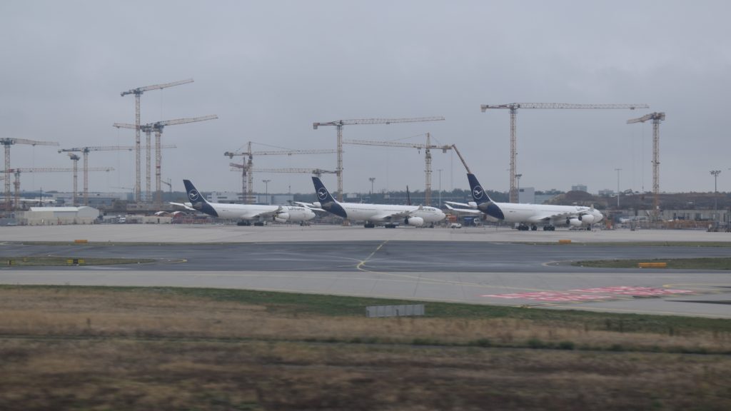 a group of airplanes on a runway