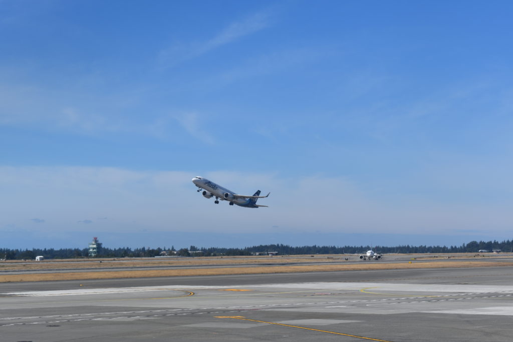 a plane flying over a runway