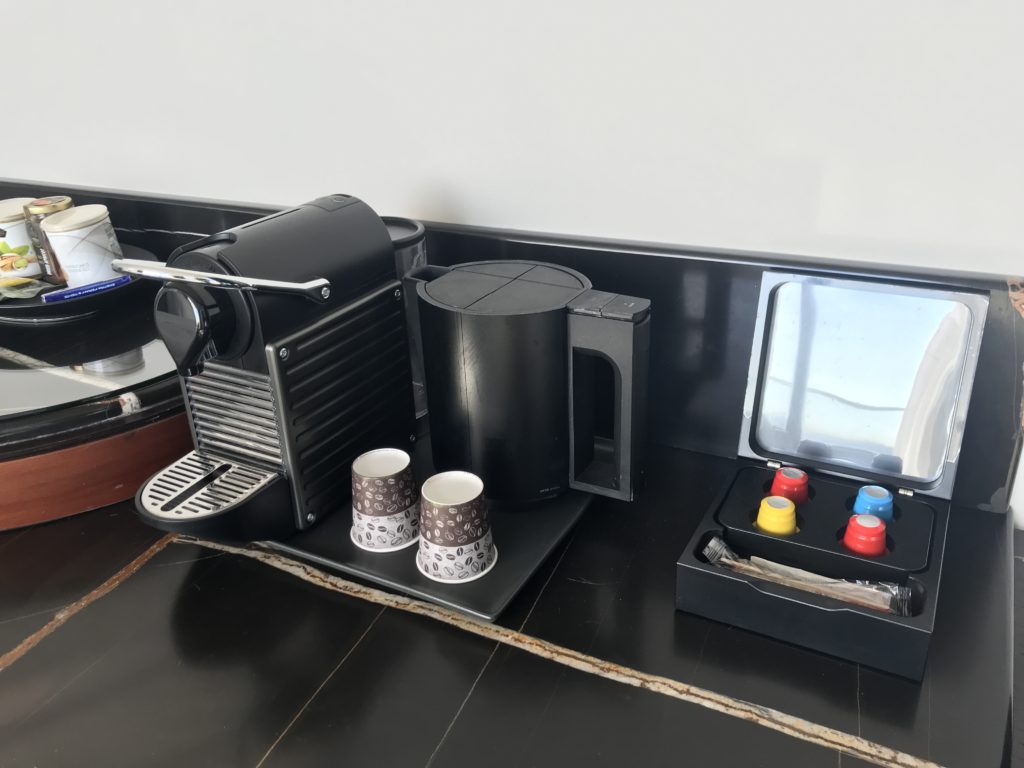 a coffee machine and cups on a counter