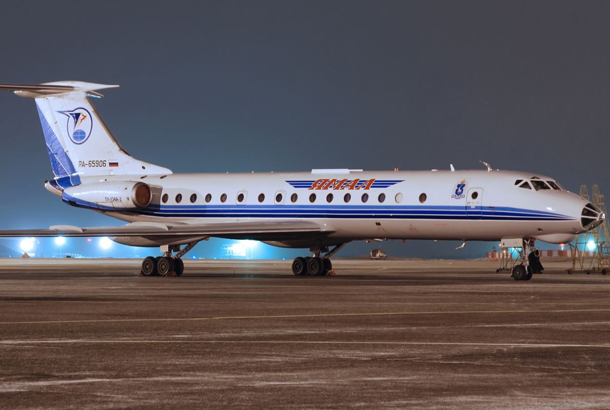 a white airplane on a runway