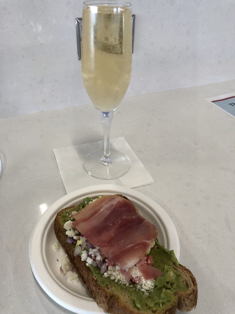 a plate of food and a glass of champagne