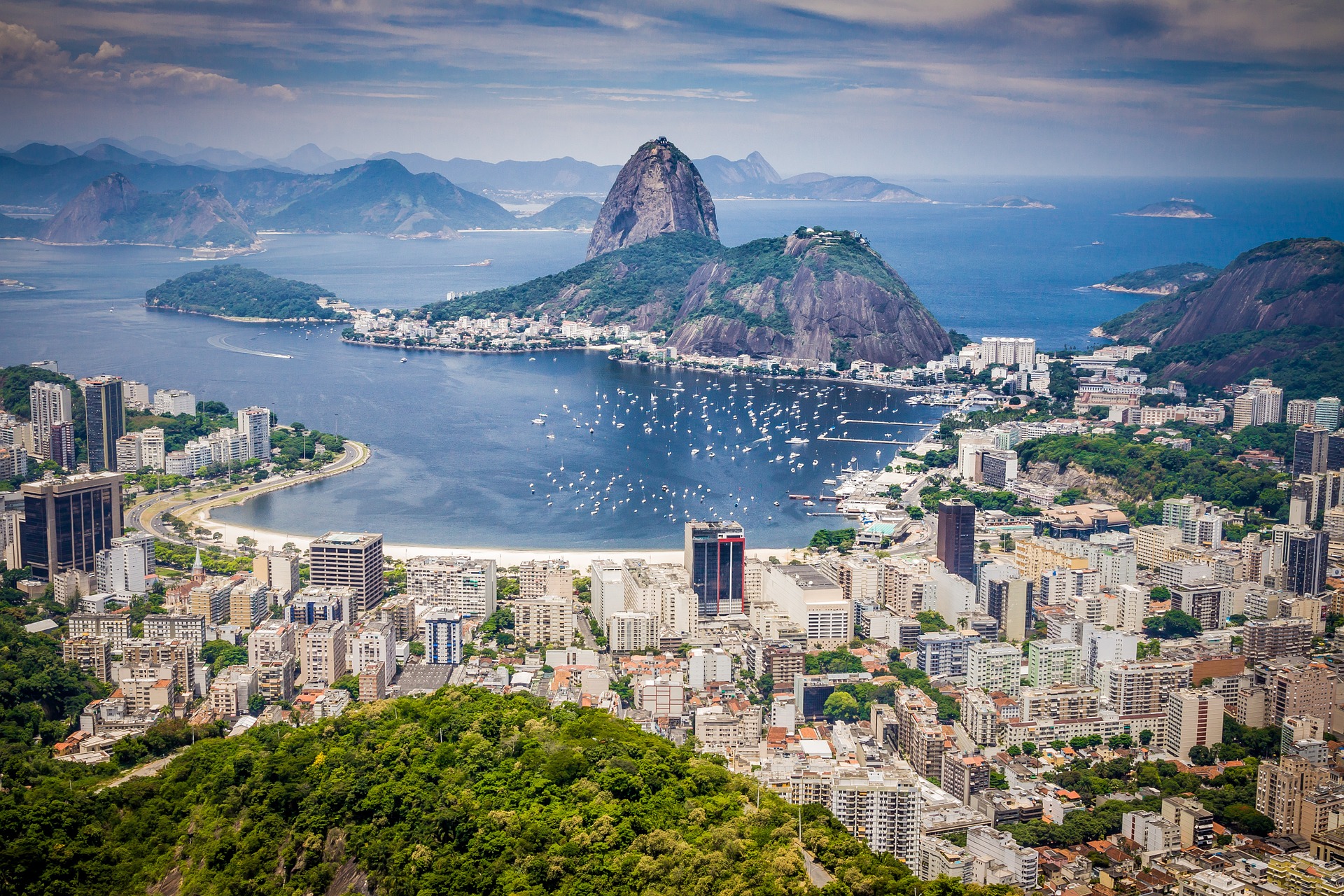 a city with a body of water and mountains