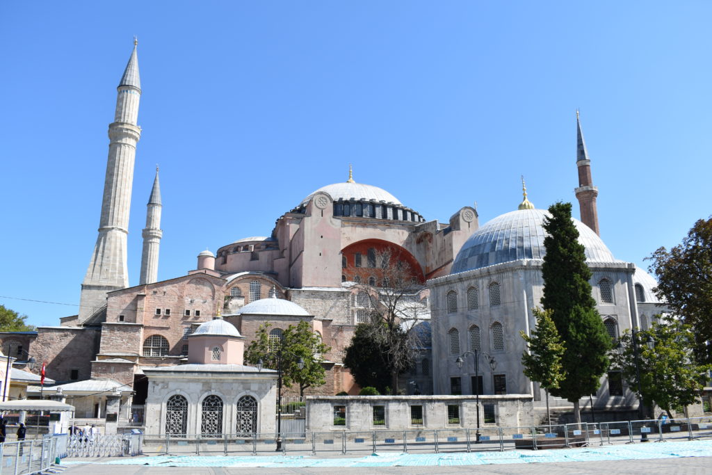 a large building with towers and a blue sky with Hagia Sophia in the background